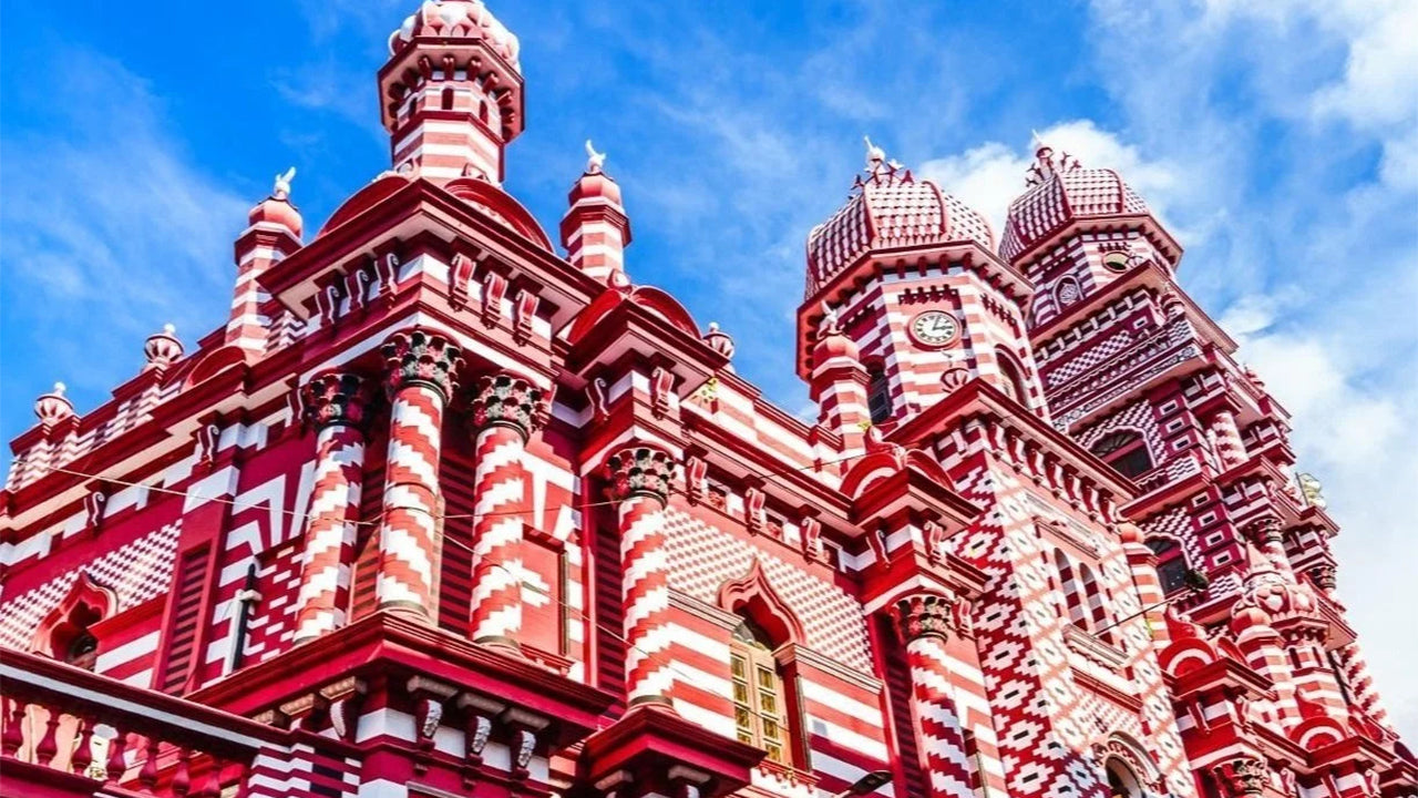 Traditional architectural building with red and white patterns against a blue sky